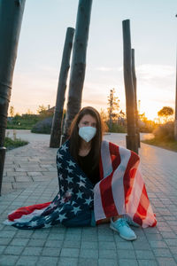 Full length portrait of woman against sky during sunset