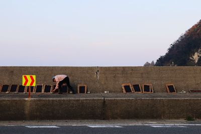 People working against clear sky