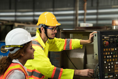 Technicians and engineers are working of machinery in industrial plants. discussing working.