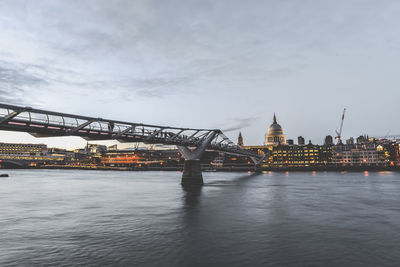 Bridge over river with city in background