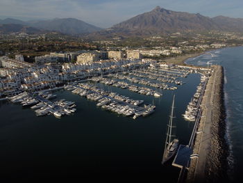 High angle view of bay and cityscape against sky