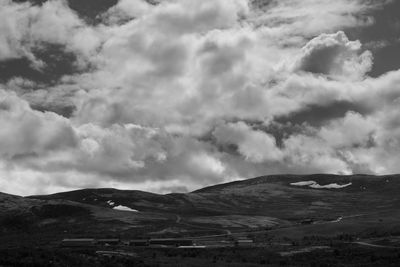 Scenic black and white view of landscape against sky