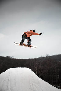 Low angle view of man standing on snow