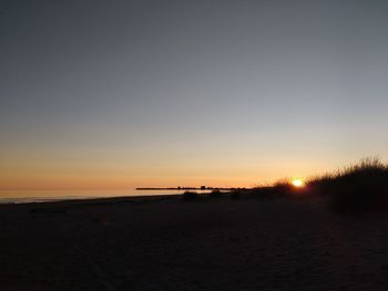 Scenic view of sea against clear sky during sunset