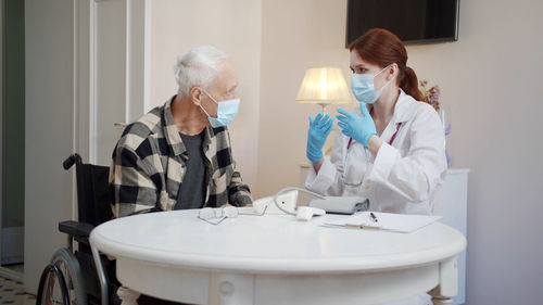 Female doctor examining patient at clinic