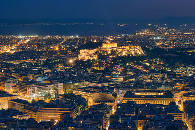 High angle view of illuminated cityscape against sky at night