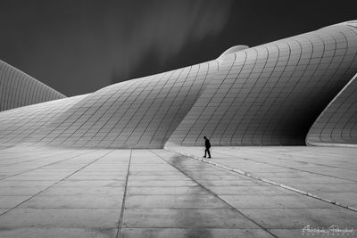 Rear view of person walking on footpath