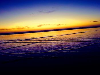 Scenic view of sea against orange sky