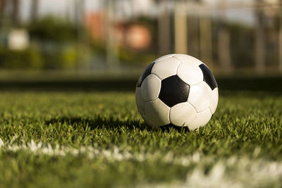 Close-up of soccer ball on field