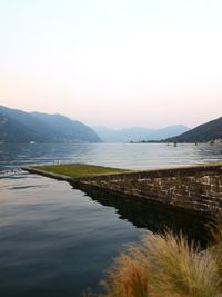 Scenic view of lake and mountains against clear sky