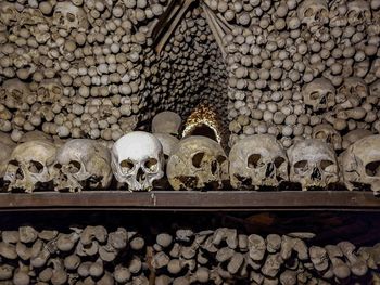 Human skulls against patterned wall