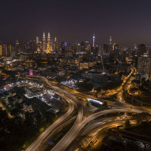 High angle view of illuminated city buildings at night