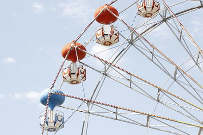 Low angle view of ferris wheel against sky