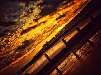 Scenic view of beach against sky at sunset