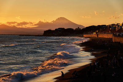 Scenic view of beach against sky during sunset