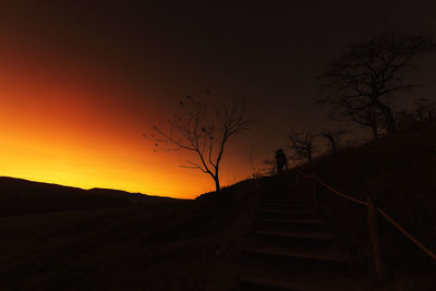 Silhouette staircase against sky during sunset