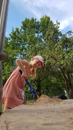 Portrait of girl playing with sand at playground