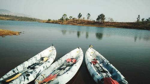 High angle view of boats moored in lake against sky