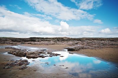 Scenic view of sea against cloudy sky