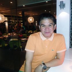 Portrait of smiling man standing in restaurant