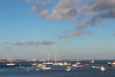 High angle view of boats moored in harbor against sky during sunset