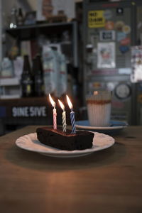 Lit tea light candles on table