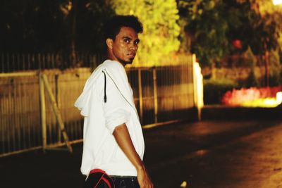 Portrait of young man standing outdoors