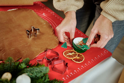 Process of woman making gingerbread cookies at home