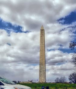 Low angle view of building against cloudy sky