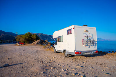 Scenic view of desert against clear blue sky