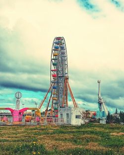 View of field against cloudy sky