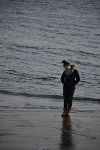 Full length of woman standing at beach