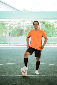 Portrait of young woman exercising in gym