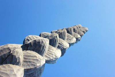 Low angle view of tall building against clear blue sky