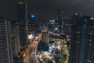 Illuminated cityscape against sky at night