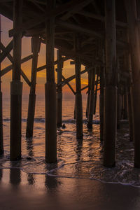 Pier over sea during sunset