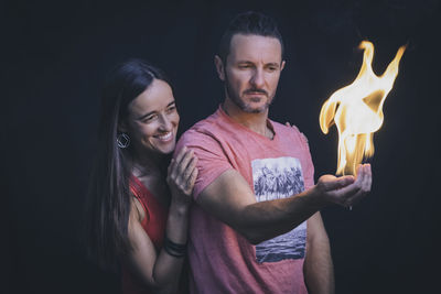 Beautiful couple with the male holding fire in his hand