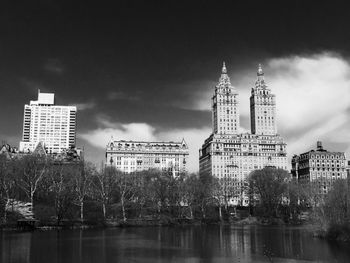 Skyscrapers against cloudy sky