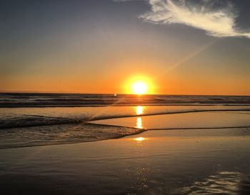 Scenic view of beach against sky during sunset