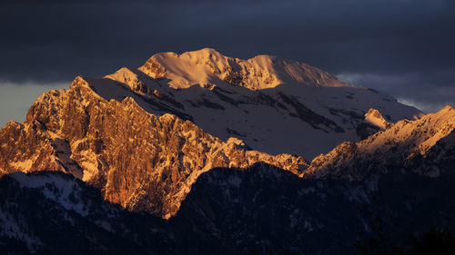 Scenic view of snow covered rock formation against sky