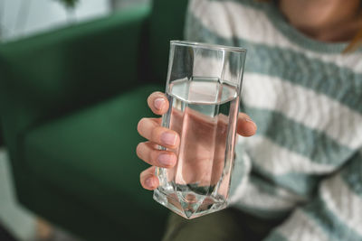 Cropped hand of woman holding drink