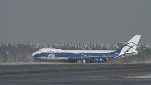 Airplane on road against sky