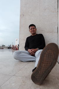 Portrait of a smiling young man sitting outdoors