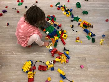 High angle view of girl playing with toys on floor