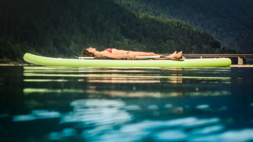 High angle view of woman relaxing in swimming pool