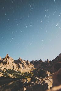 Scenic view of mountains against sky at night