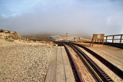 Train on railroad tracks against sky