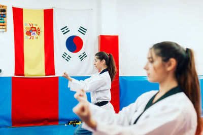 Side view of women practicing martial art