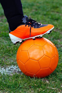 Low section of man with ball on field