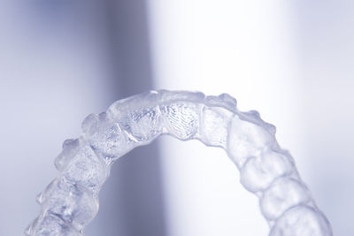 Close-up of frozen water against white background